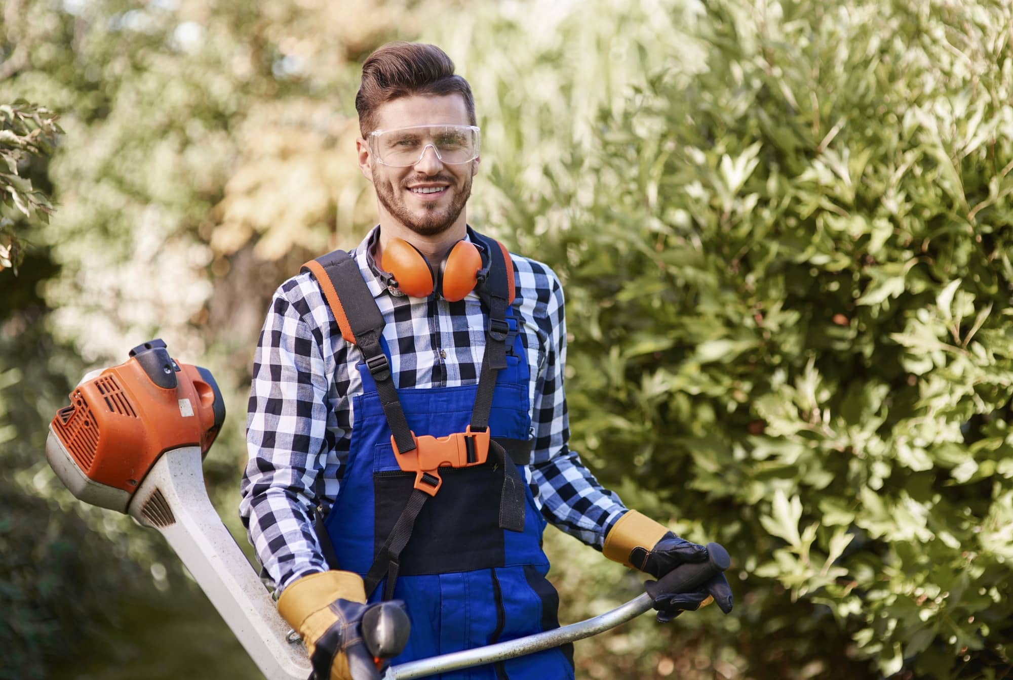 portrait of man working with weedwacker