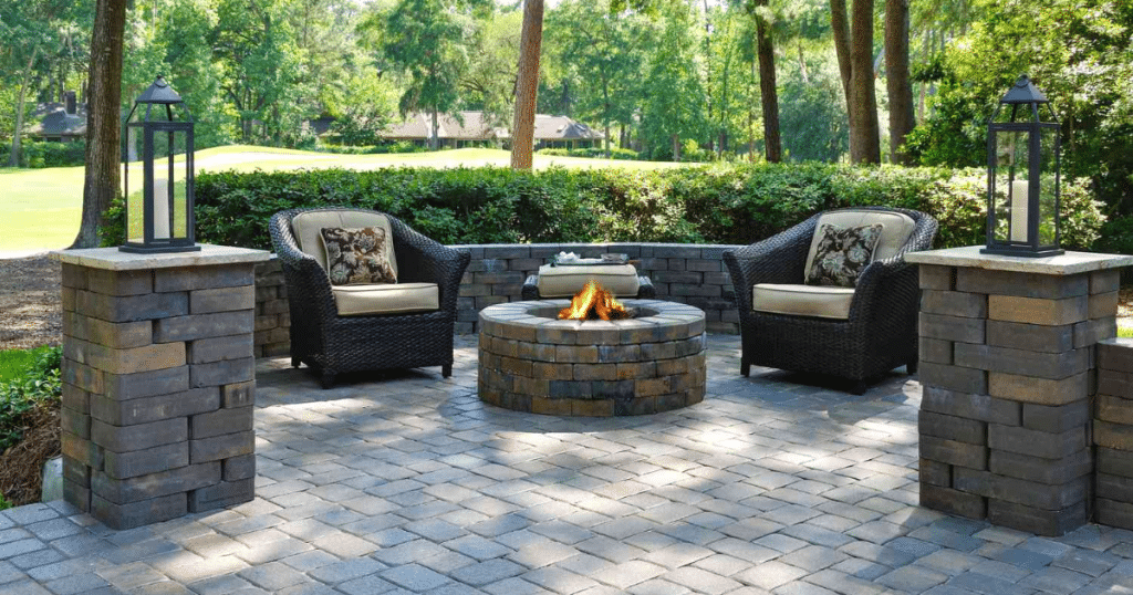 Outdoor patio with fire pit and chairs.