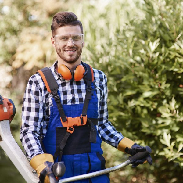 portrait of man working with weedwacker